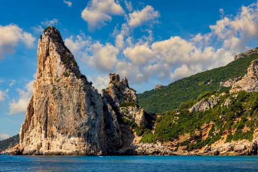 The monolith of Pedra Longa, Baunei, province of Ogliastra, East Sardinia, Italy. The rocky spire which rises majestically out of the sea. Holidays in Sardinia, Italy.