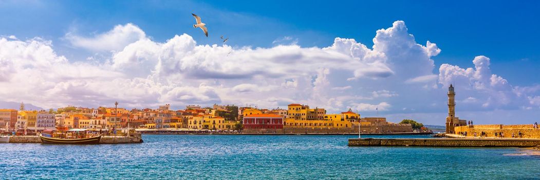 Old port of Chania with flying seagulls. Landmarks of Crete island. Bay of Chania at sunny summer day, Crete Greece. View of the old port of Chania, Crete, Greece. The port of chania, or Hania. 