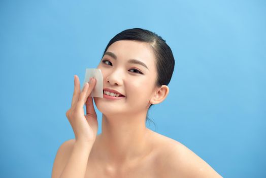 Beautiful Attractive Asian woman using Facial oil clean film to removal oily on face for face fresh skin feeling so fresh and clean,