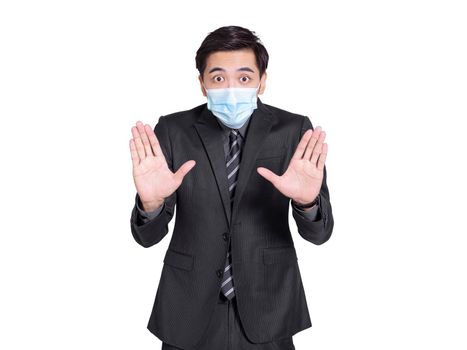 young businessman wearing a medical mask, looking at the camera in surprise, made  gesture of rejection