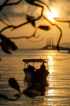 Silhouette a boat with Penang Bridge