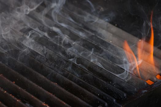 Cast iron metal grill grate with fire and smoke