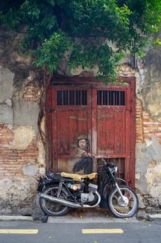 Mural kid on old motorcycle