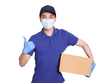 Young courier wearing blue clothes and hats, protective masks and gloves to protect himself, delivering packages during the covid-19 epidemic, and showing thumbs-up gesture