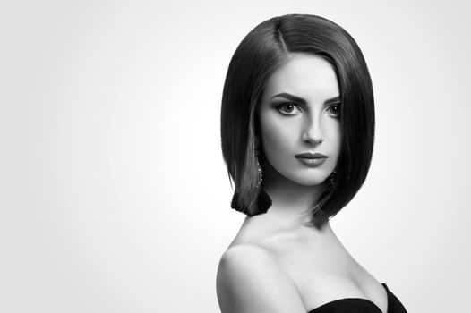Black and white studio shots of a classy young woman with short