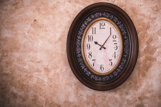 Classic Antique Clock Hanging on Isolated Retro Wall Background, Vintage Ellipse Timer Clock.