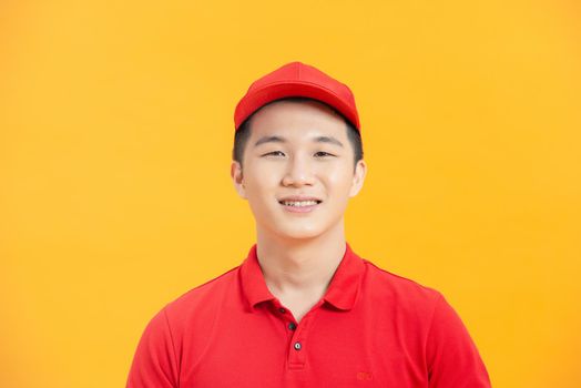 happy deliveryman worker wearing cap and uniform looking at camera