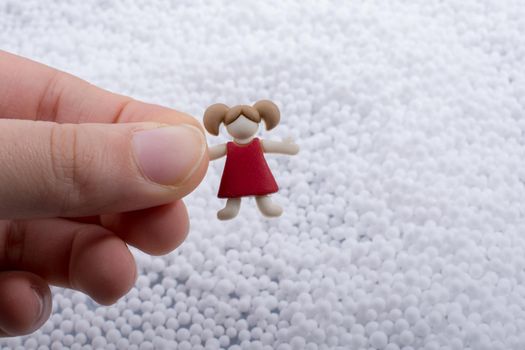 Little girl  figurine in hand on white background