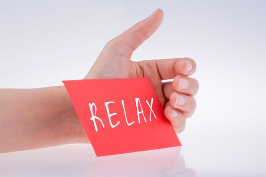 Relax wording written on paper in hand