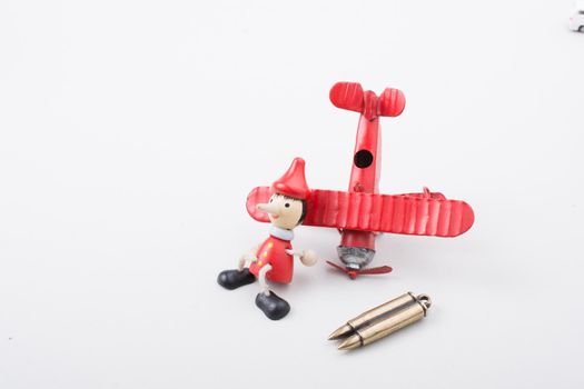 Airplane, Bullet and wooden pinocchio doll