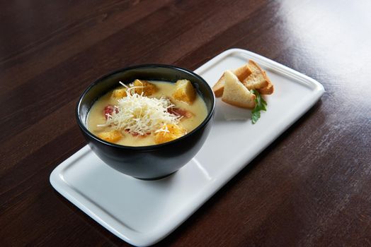 Cheese soup with croutons on a restaurant table