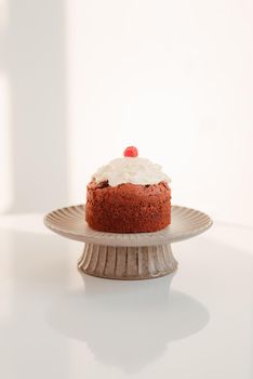 Stand with piece of delicious homemade raspberry cupcake