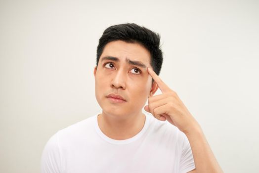 Men squeezing a pimple on white background