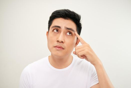 Men squeezing a pimple on white background