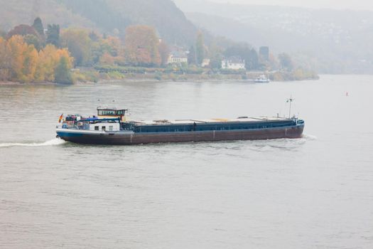 Cargo vessel navigating river Rhine Germany
