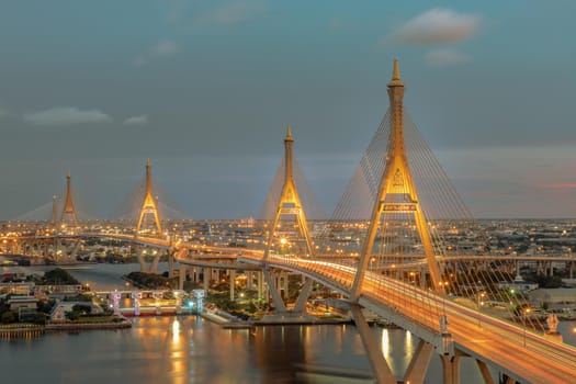 Bhumibol suspension bridge cross over Chao Phraya River at evening.