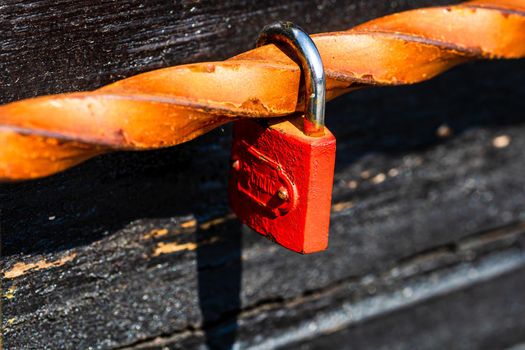 Love symbol, old rusty padlocks hanging on wooden fortress bridge in Alba Iulia, Romania, 2021