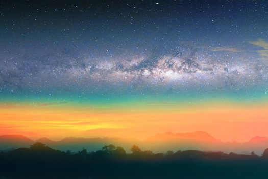 Milky way night landscape sunset rainbow light over silhouette mountain