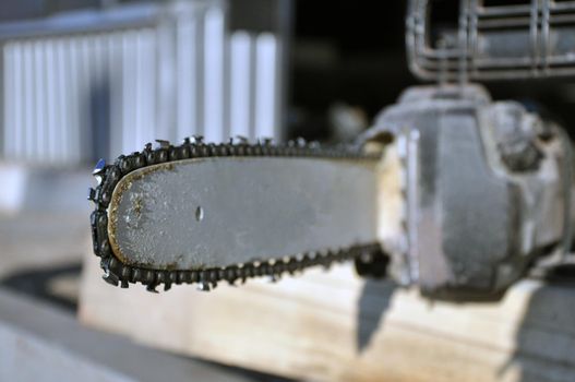Chainsaw. Close-up of saw chain with residues of sawdust and wood dust.