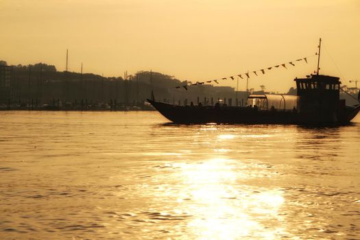 Typical portuguese boats called Rabelos crossing the Douro River